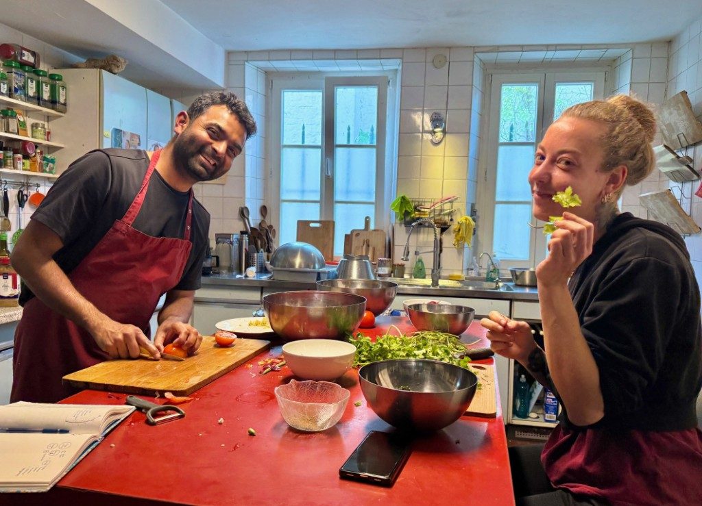 Volunteers cooking in the Open Sky House kitchen